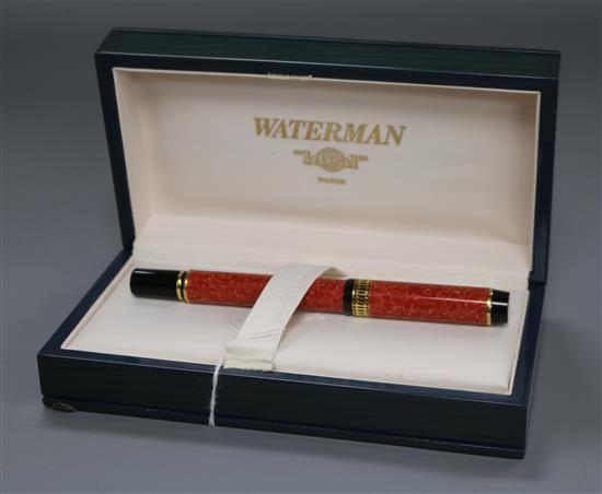 A Waterman Ideal fountain pen, in marbled red, black and gilt, in lacquered box